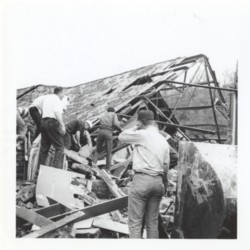 Workers Assessing the Damage to Tony Boll&#039;s Farm Supply